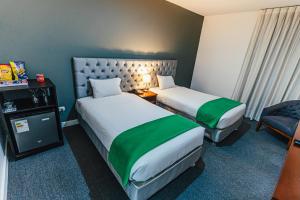 Postel nebo postele na pokoji v ubytování Hotel Hacienda Lima Norte
