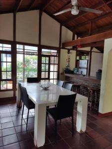 a dining room with a white table and chairs at Las Palmeras casa en Melgar in Melgar