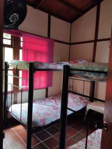 two bunk beds in a room with a window at Las Palmeras casa en Melgar in Melgar