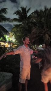 a man standing on the beach with his arms out at Villa on The Beach Seaside Sunrise Haven 7 bedroom in Cancún