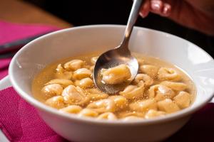 a bowl of macaroni and cheese with a spoon at Phi Hotel Bologna in Bologna