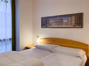 Een bed of bedden in een kamer bij Qui e Ora House