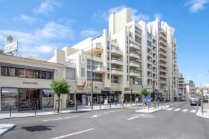 Un gran edificio blanco en una calle de la ciudad. en Biarritz - Residence Victoria surf - Face océan, en Biarritz