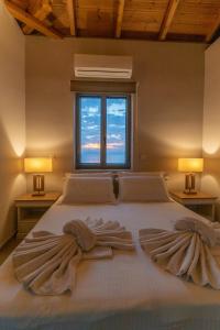 Postel nebo postele na pokoji v ubytování Mythos Villas