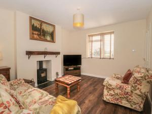 a living room with a couch and a table at Coronation Cottages No 2 in Weston-super-Mare