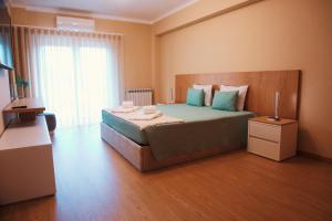 a bedroom with a large bed with blue pillows at Celorico Village AP in Celorico de Basto
