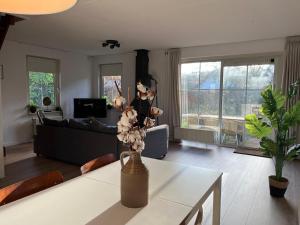 a living room with a table and a couch at Vakantiewoning 'Eysinga State' in Sint Nicolaasga
