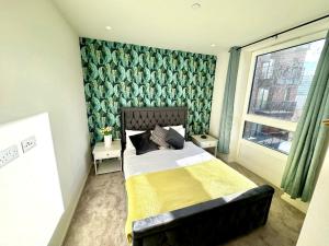 a bedroom with a bed and a window at East London Riverside in London