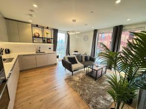 a kitchen and living room with a couch and a table at East London Riverside in London