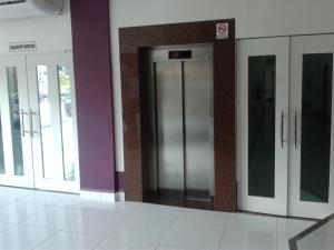 a row of elevator doors in a building at Hotel Açay in Santarém