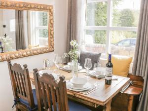 a dining room table with a mirror and a table with chairs at 31 Riverside in Bridgnorth