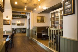 a restaurant with a bar and a dining room at Bridge End Hotel in Llangollen