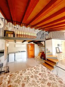 a large living room with a staircase and a stair case at Le dimore Al Vecchio Teatro in Ortona