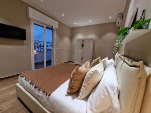 a bedroom with a large bed with white pillows at Piccole Donne in Naples