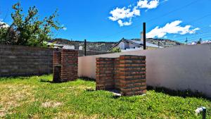 a stack of bricks in a yard next to a fence at MG ESQUEL in Esquel