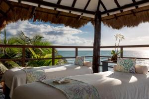 two beds in a room with a view of the ocean at El Dorado Seaside Palms A Spa Resort - More Inclusive in Akumal