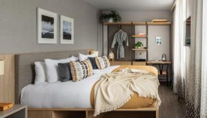 a bedroom with a large white bed with pillows at Inhabit Southwick Street, a Member of Design Hotels in London