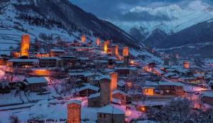 a small town in the snow at night at Guest house-Lile in Mestia