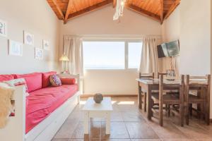 a living room with a red couch and a table at Beautiful Apartment Downtown, Amazing Lake Views JF1 by Apartments Bariloche in San Carlos de Bariloche