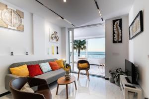 a living room with a couch and a view of the ocean at La Roca Chica in Torremolinos