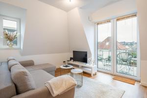 Una sala de estar con un sofá y un televisor. en Neubau Wohnung am Eversten Holz, en Oldenburg