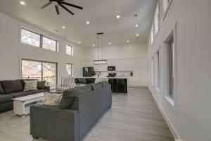 a living room with a couch and a kitchen at Bright Cotter Vacation Rental with White River Views in Cotter