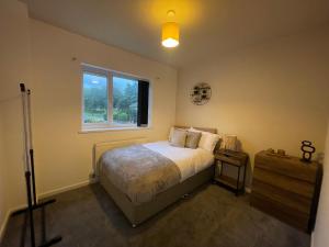 a bedroom with a large bed and a window at Modern Spacious 5 Bed House in Newcastle in Newcastle upon Tyne