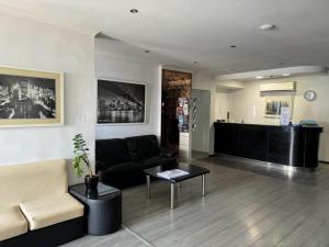 a living room with a couch and a table at Roma Hotel in Sliema