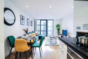 a kitchen and living room with a table and chairs at Canary Wharf-Stylish Flat-Fibre Wi-fi-10% discount in London