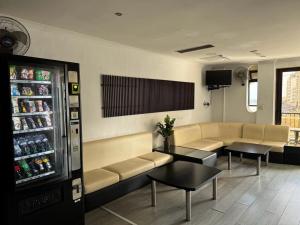 a waiting room with a couch and a drink refrigerator at Roma Hotel in Sliema