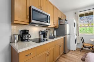 a kitchen with a sink and a refrigerator at @Marbella Lane - Blissful Studio in Makaha in Waianae
