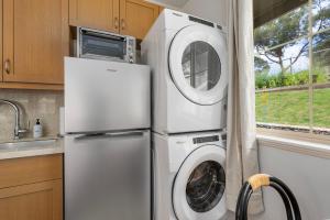 a washing machine and a washer and dryer in a kitchen at @Marbella Lane - Blissful Studio in Makaha in Waianae