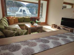 a living room with a couch and a table at Apartman Adna in Trnovo