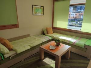 a living room with two beds and a table at Apartman Adna in Trnovo