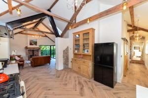 a kitchen with a black refrigerator in a room at Bramble Cottage, hidden gem in Comber near Belfast in Ballygowan