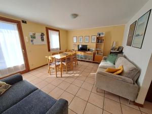 a living room with a couch and a table and a kitchen at Casa Alba in Borso del Grappa