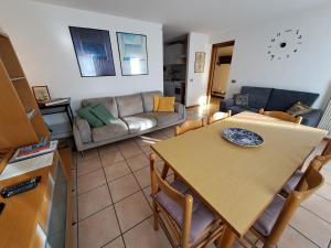 a kitchen and living room with a table and a couch at Casa Alba in Borso del Grappa