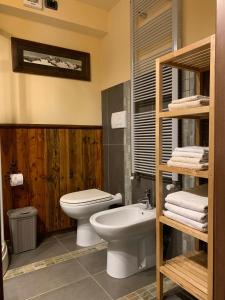 a bathroom with a white toilet and a sink at Monte Emilius Alloggio ad uso turistico VDA SAINT CHRISTOPHE n 0002 in Saint-Christophe