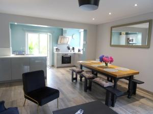 a kitchen and dining room with a table and chairs at Abri Cotier in Hautot-sur-Mer +19 photos