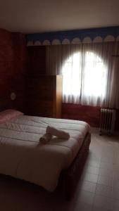 ロス・アルカサレスにあるMediterraneo y Luminosoのベッドルーム1室(タオル付きのベッド1台付)
