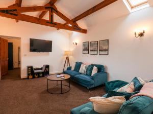 a living room with two blue couches and a table at Puffin in Bridlington