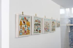 a row of framed pictures on a wall at La Bella Annacapri in Anacapri