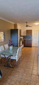 a kitchen with a table and chairs and a refrigerator at Apt. Faraj in Playa de las Americas