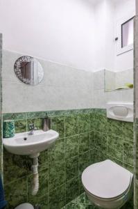 a bathroom with a toilet and a sink at Spacious 3BD Central apartment in Sofia