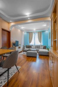 a living room with a couch and a table at Spacious 3BD Central apartment in Sofia