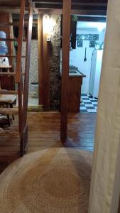 a room with a kitchen and a staircase in a house at Casa Rústica Lisboa 100m da praia in Balneário Camboriú