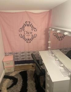 a room with a pink curtain and a table and chairs at Cozy Basement Apartment in Brampton