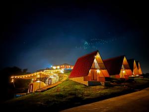 a row of houses lit up at night at Villa de los Vientos in Cuetzalán del Progreso