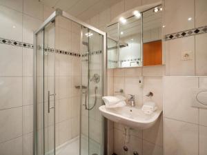 a bathroom with a sink and a shower at Gasthof Mamooserhof in Penning