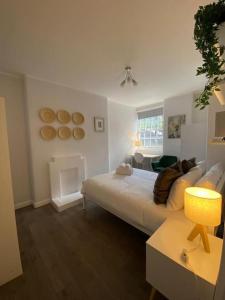 a living room with a bed and a fireplace at London's Charm - Best Spot in Modern 2BR, King's Cross in London